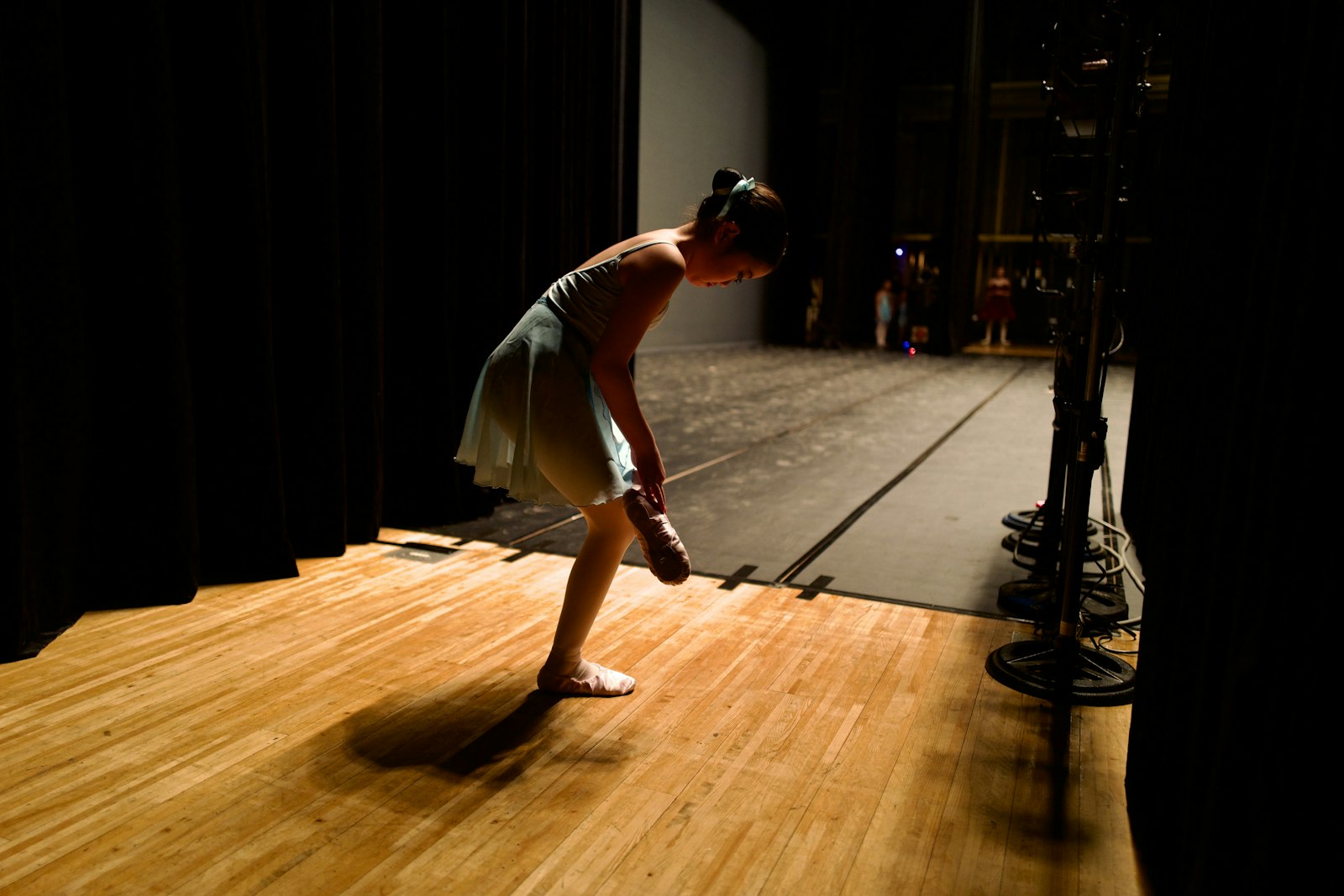 A lone dancer rehearsing on an empty stage
