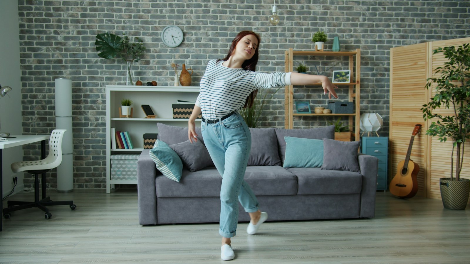 A woman dancing in her living room at home